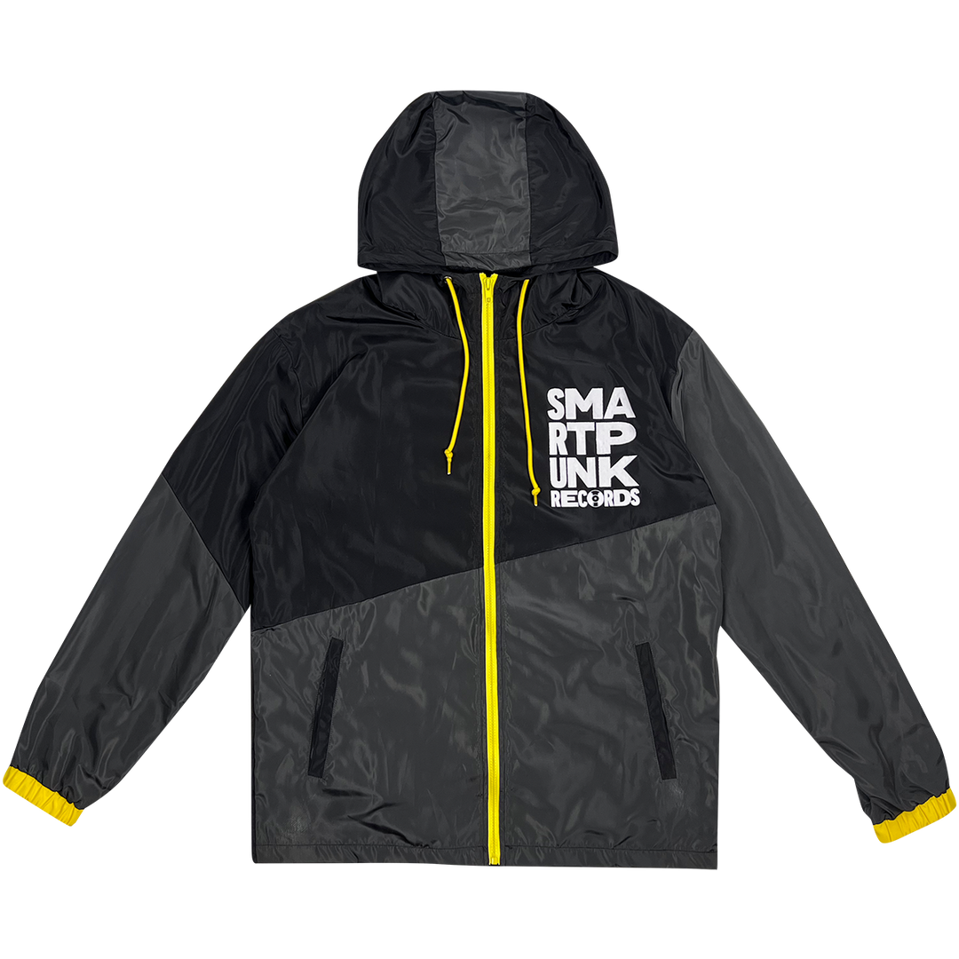 Black and grey windbreaker with yellow accents and stacked "Smartpunk" logo RONT